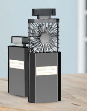DROPPZZA Perfume fan design with crystal fan, stylish and portable on a wooden surface.