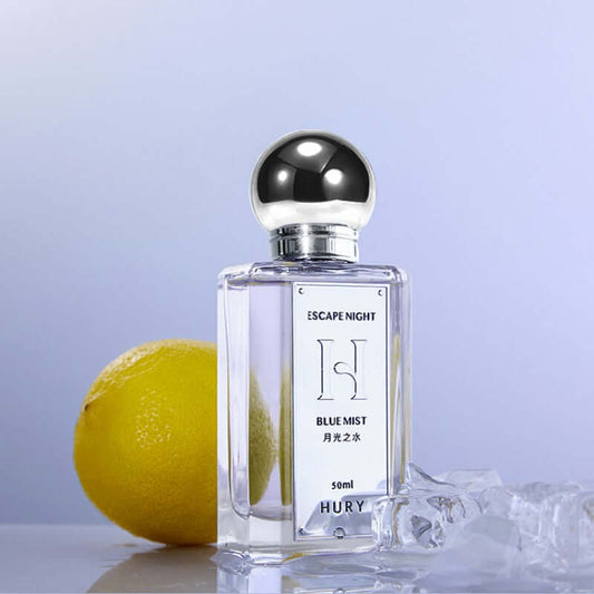 DROPPZZA Aromatic Citrus Aromatic Perfume displayed beside a lemon, showcasing its refreshing scent.